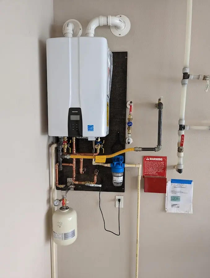Professional plumber installing copper piping in a Ranchettes home